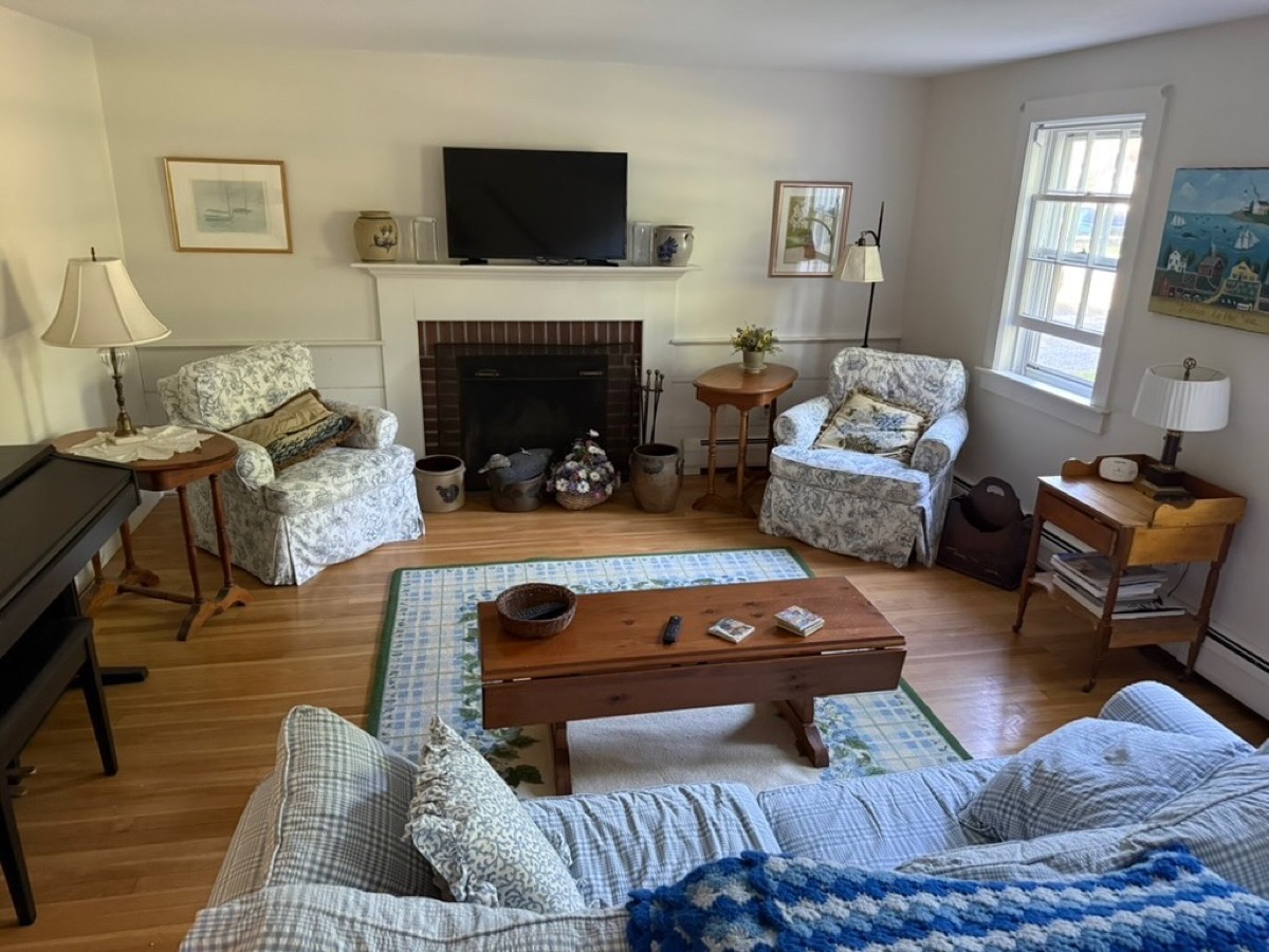 Living room / TV room with coastal blue decor and brick fireplace