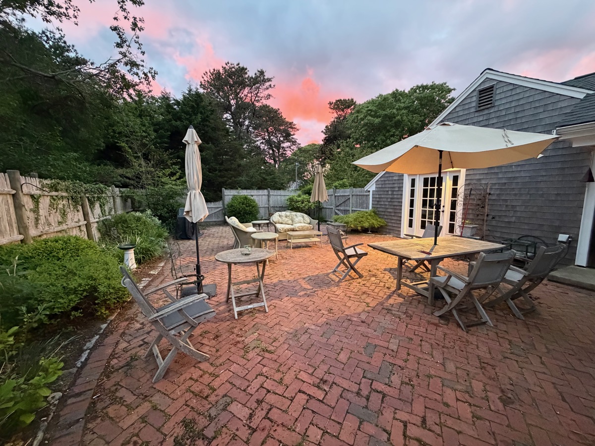 Brick patio with outdoor dining at sunset
